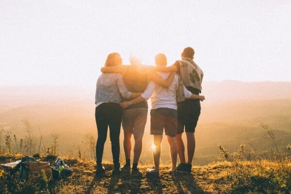 A group of people standing on top of a hill.