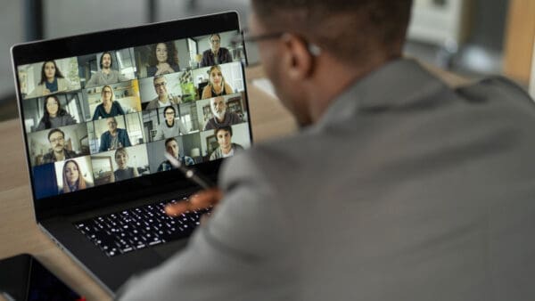 A man is on his laptop and looking at the screen.